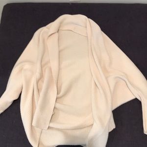 Cream colored batwing knitted cardigan.